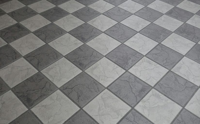 Podłoga wyłożona szaro-białymi płytkami ceramicznymi w układzie ukośnym.